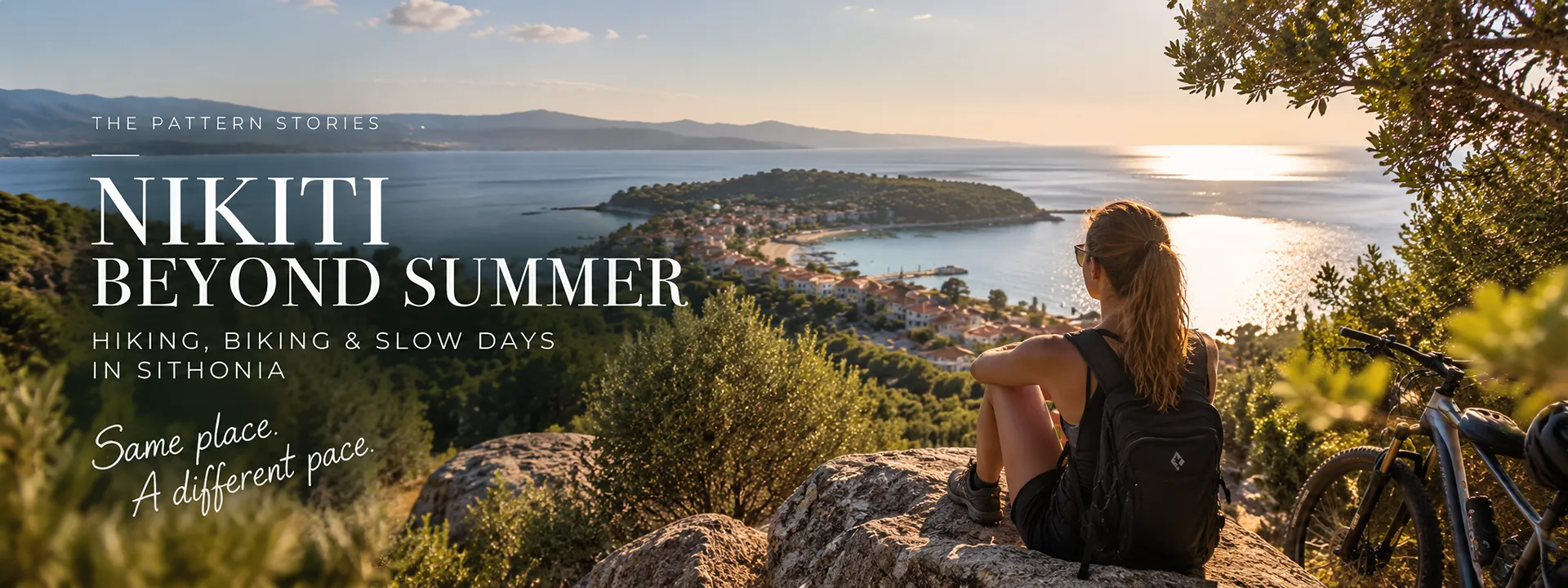 Hiker with mountain bike looking over Nikiti bay — hiking and biking in Sithonia, Halkidiki, beyond summer